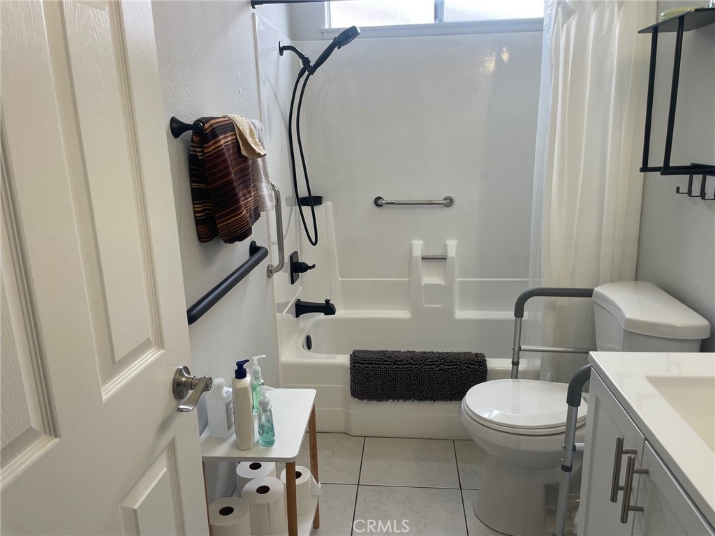 26592 Farrell Street Menifee, CA 92586 - Photo 25 of 31 a bathroom with a toilet sink and mirror