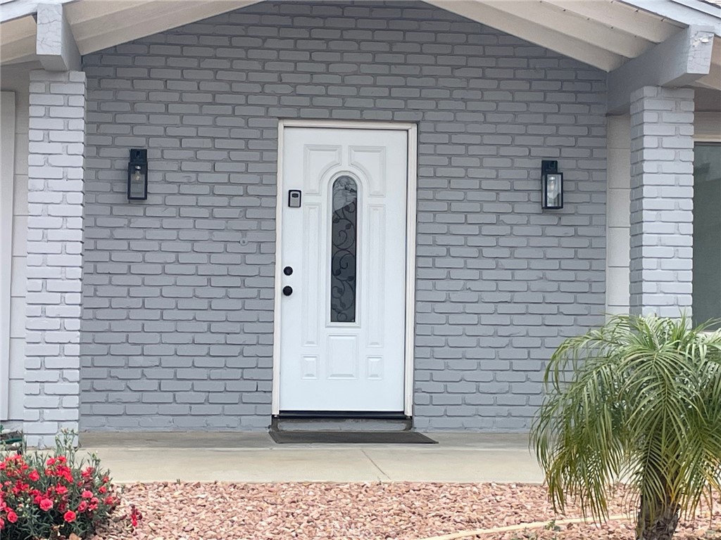 26592 Farrell Street Menifee, CA 92586 - Photo 3 of 31 a view of a brick house with potted plants