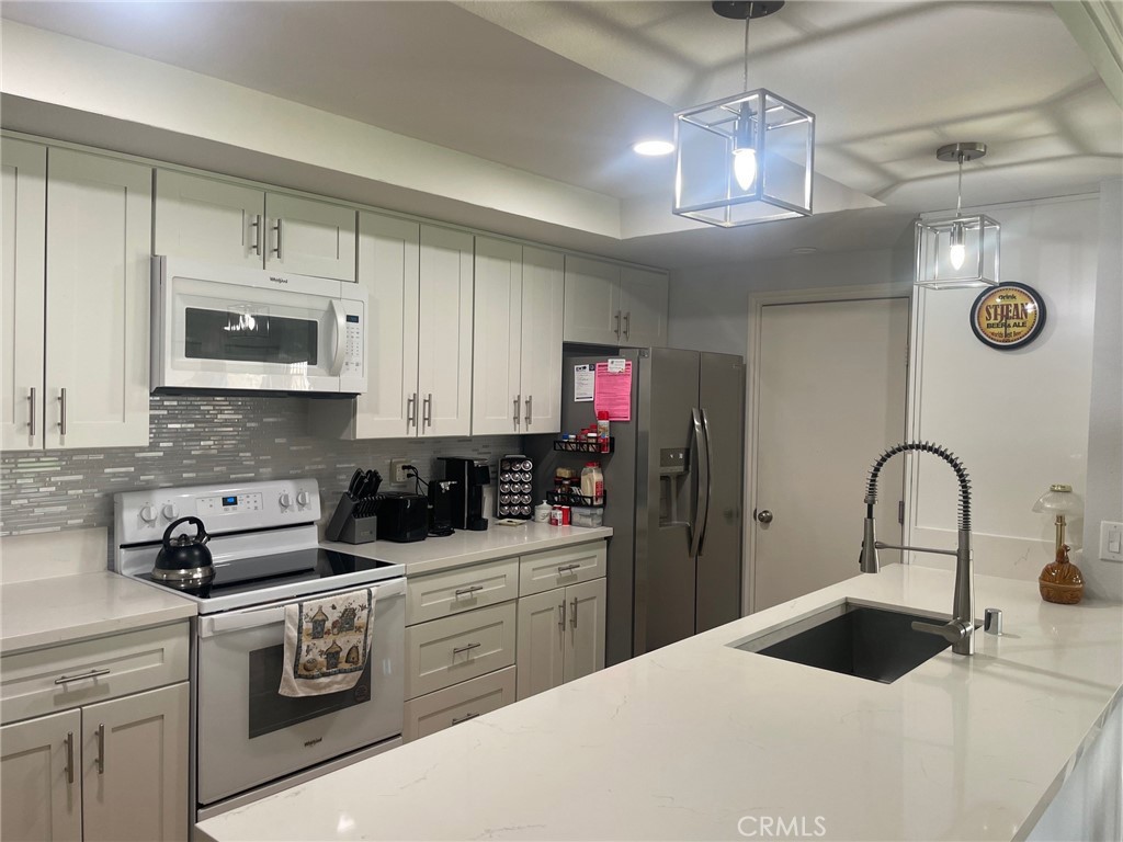 26592 Farrell Street Menifee, CA 92586 - Photo 5 of 31 a kitchen with a sink and cabinets