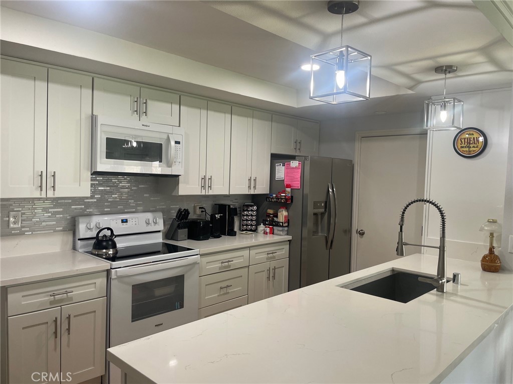 26592 Farrell Street Menifee, CA 92586 - Photo 6 of 31 a kitchen with a sink a stove and cabinets