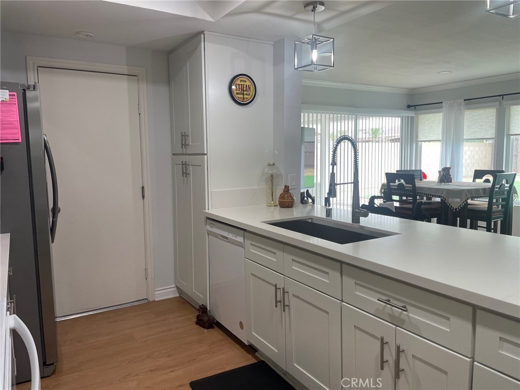 26592 Farrell Street Menifee, CA 92586 - Photo 9 of 31 a kitchen with stainless steel appliances a refrigerator a sink and cabinets