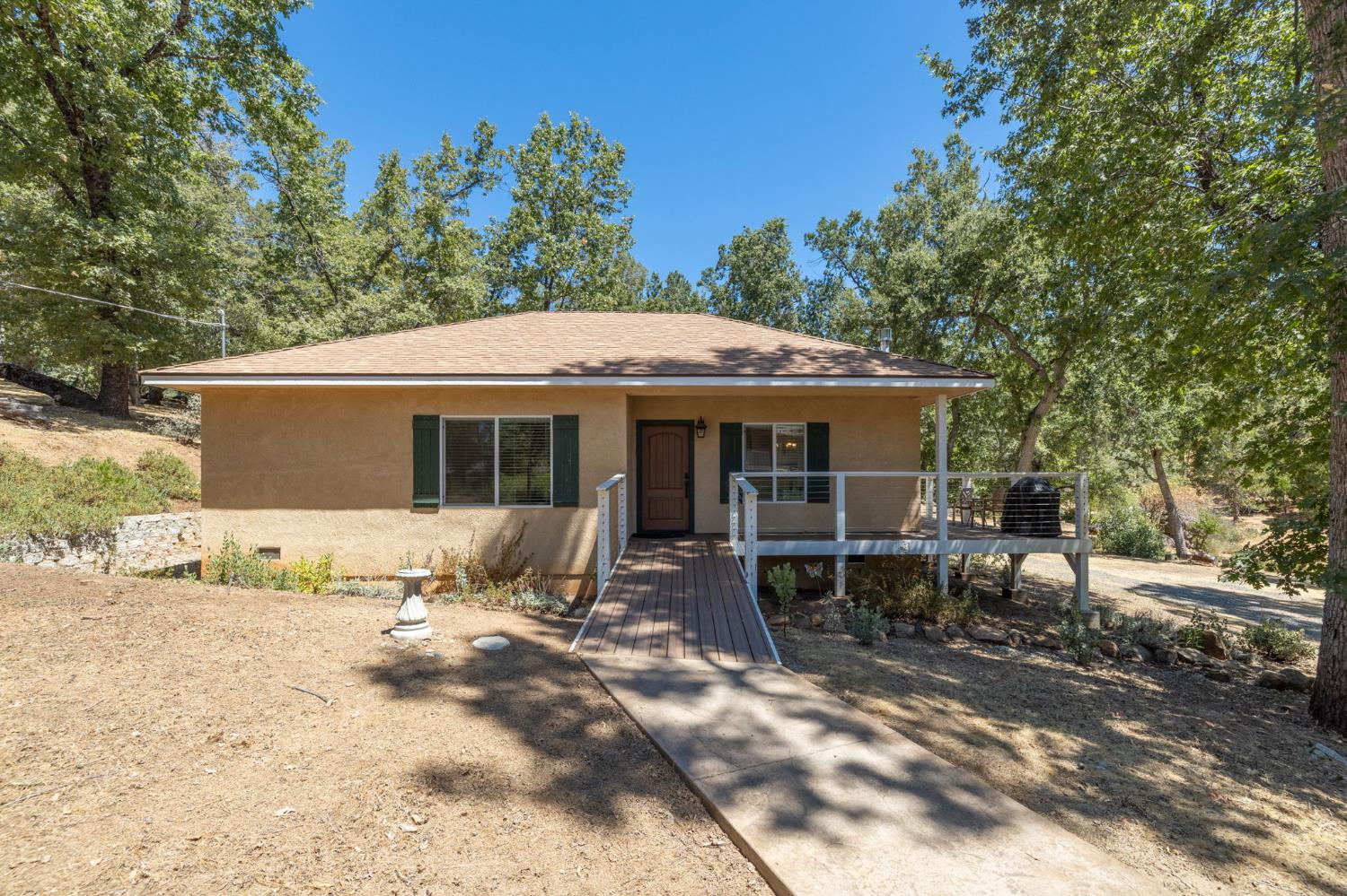 34811 Wintergreen Loop North Fork, CA 93643 - Photo 37 of 76 a front view of a house with a yard and outdoor seating