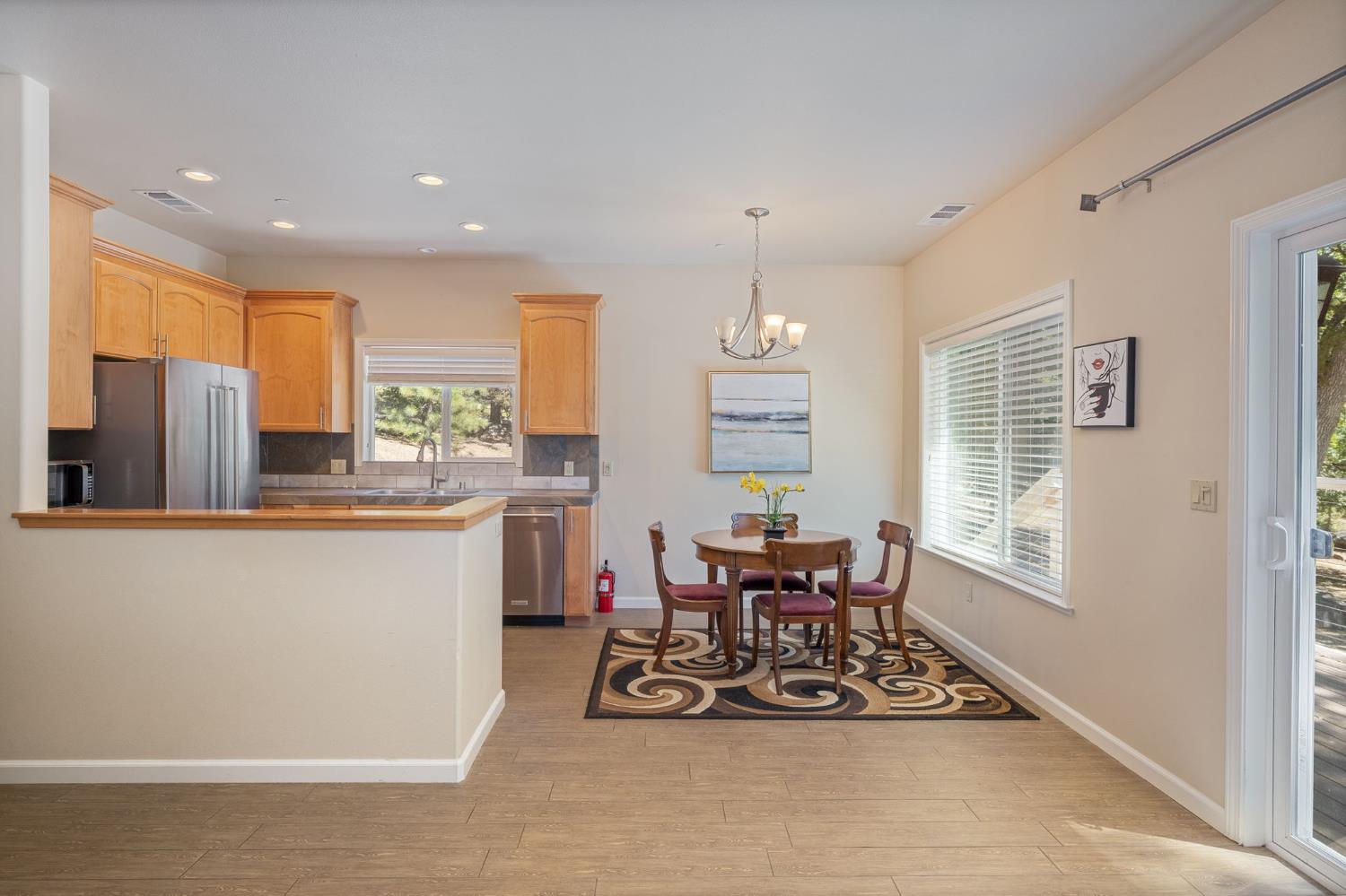 34811 Wintergreen Loop North Fork, CA 93643 - Photo 41 of 76 a kitchen with stainless steel appliances kitchen island granite countertop a refrigerator a stove a sink dishwasher with a dining table and chairs