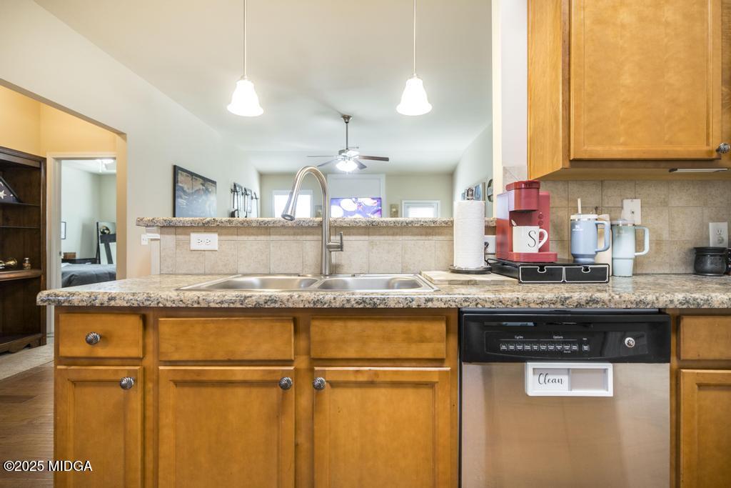 135 Abelia Lane Byron, GA 31008 - Photo 11 of 32 a kitchen with granite countertop wooden cabinets and a stainless steel appliances