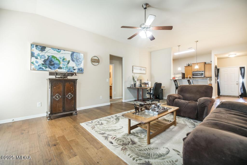 135 Abelia Lane Byron, GA 31008 - Photo 15 of 32 a living room with furniture and a wooden floor