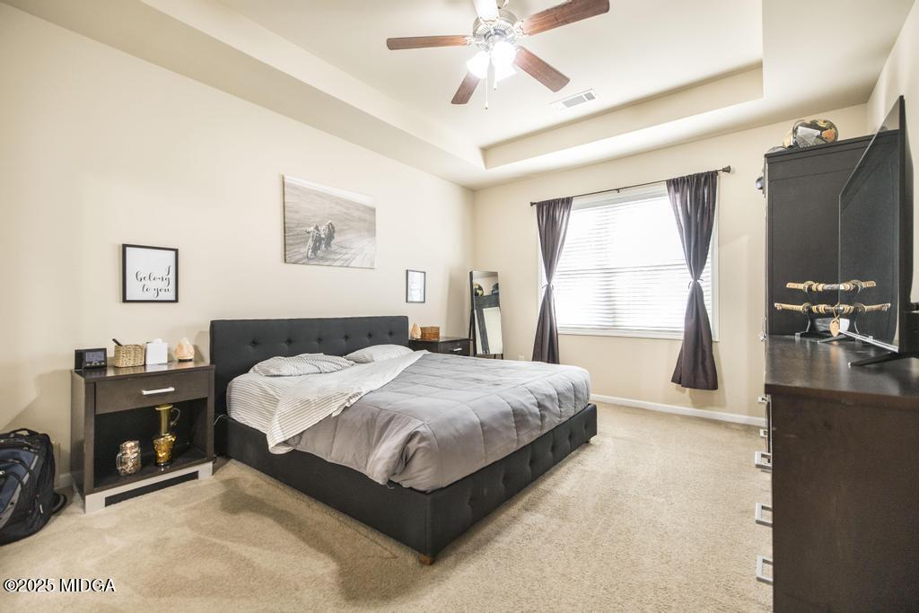 135 Abelia Lane Byron, GA 31008 - Photo 16 of 32 a bedroom with a bed flat screen tv and a large window