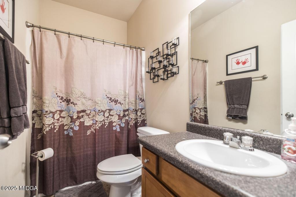 135 Abelia Lane Byron, GA 31008 - Photo 24 of 32 a bathroom with a granite countertop sink a toilet and a mirror
