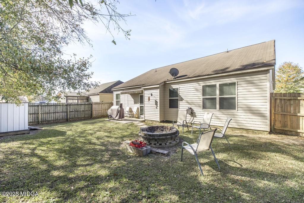 135 Abelia Lane Byron, GA 31008 - Photo 27 of 32 a backyard of a house with table and chairs