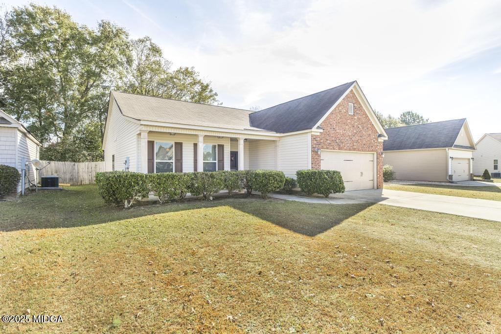 135 Abelia Lane Byron, GA 31008 - Photo 5 of 32 a view of a house with swimming pool and a yard