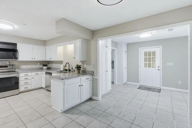 a kitchen with a sink stove and cabinets