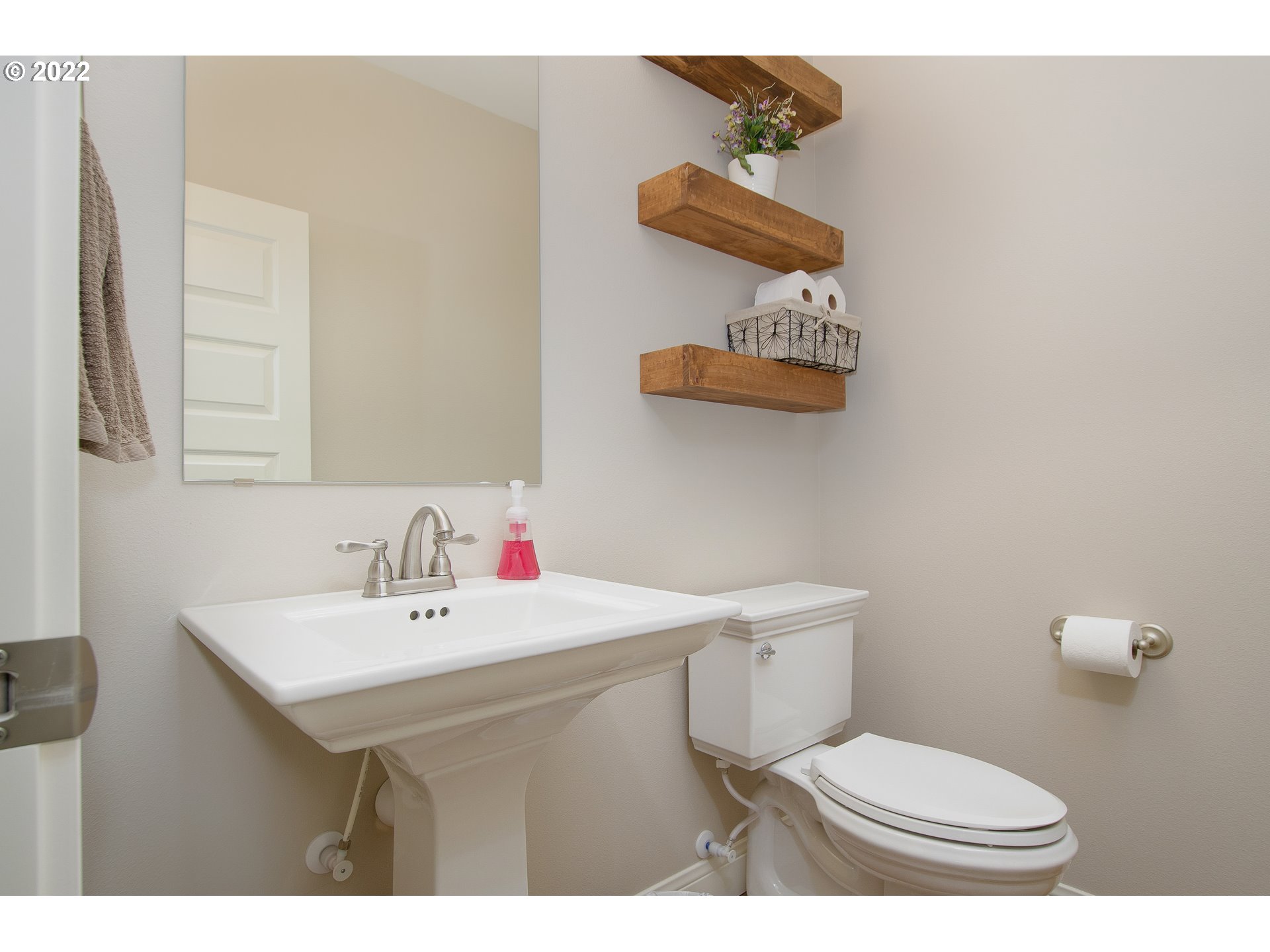 2507 Northeast 176th Street Ridgefield, WA 98642 - Photo 10 of 32 a bathroom with a sink a toilet and a mirror