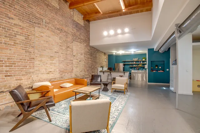 a living room with patio furniture and a fireplace