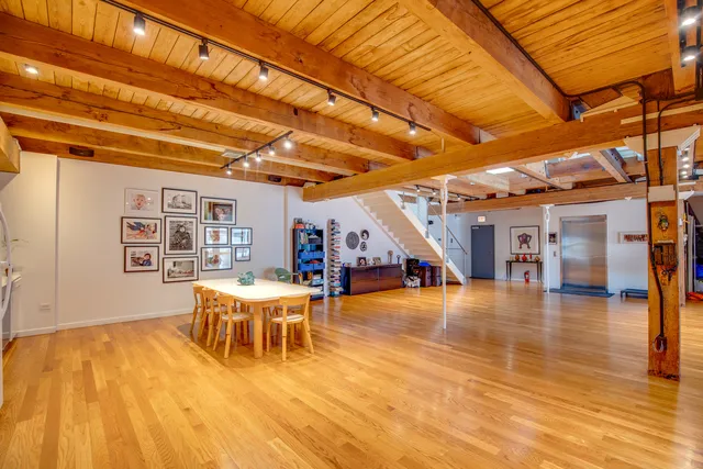 a view of a patio with table and chairs a barbeque with wooden floor and fence