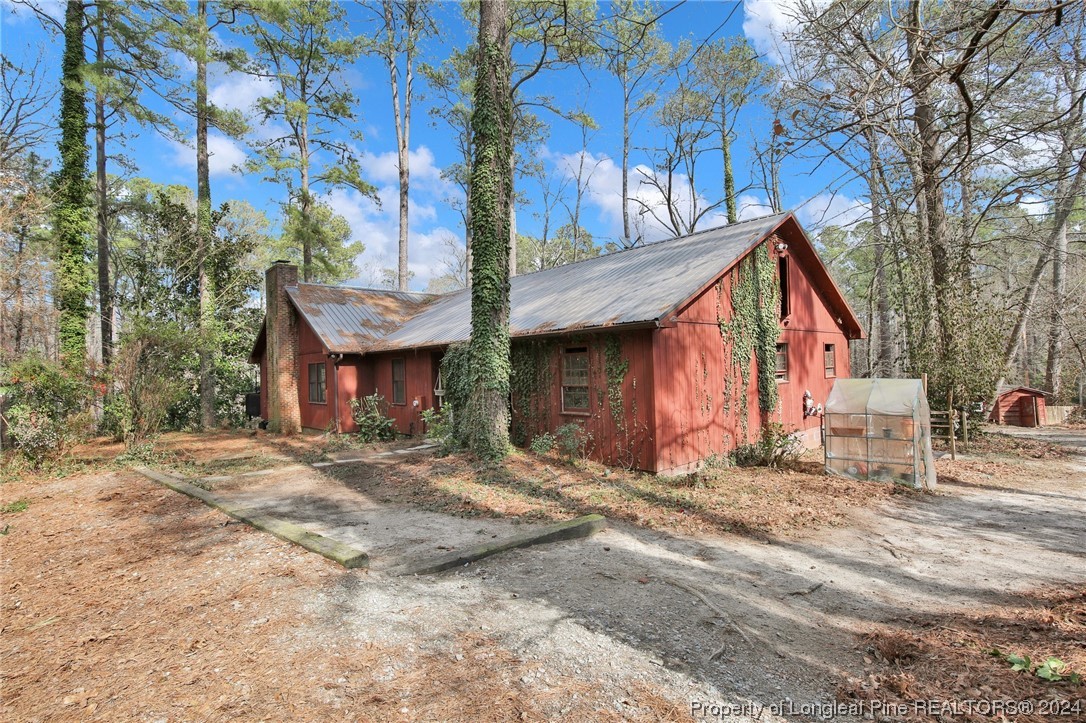 417 Farm Life School Road Carthage, NC 28327 - Photo 1 of 33 a view of a house with a yard covered in snow