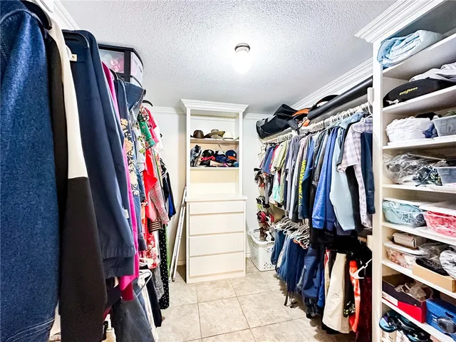 a view of walk in closet with clothes
