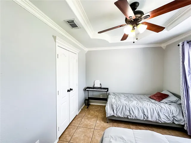 a bedroom with a bed and a ceiling fan