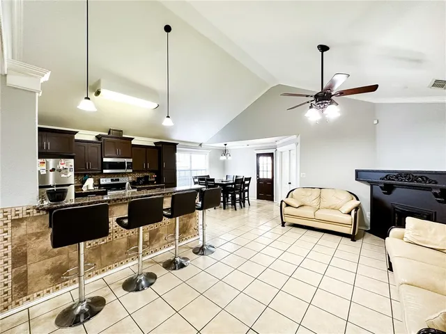 a living room with furniture and kitchen view