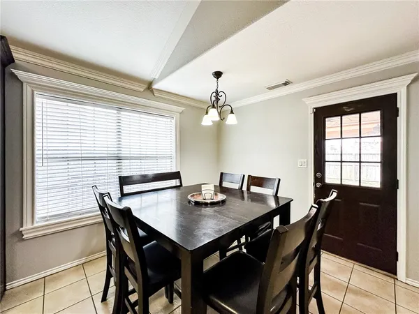 a view of a dining room with furniture and window