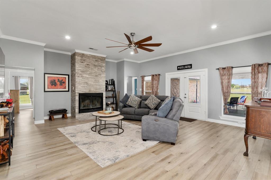 10832 Ridge Country Road Haslet, TX 76052 - Photo 13 of 30 Main living room with wood-burning fireplace, stacked stone, & double doors to the patio & pergola-covered deck!