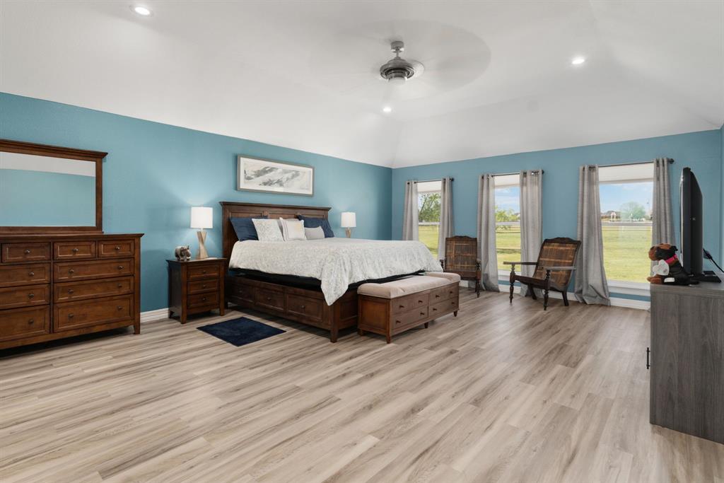 10832 Ridge Country Road Haslet, TX 76052 - Photo 14 of 30 Massive primary suite with triple windows on the back, LVP flooring, & a soft & relaxing paint color.