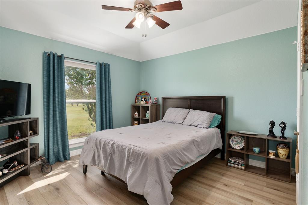 10832 Ridge Country Road Haslet, TX 76052 - Photo 18 of 30 Relaxing secondary bedroom with walk-in closet & window to the front yard.