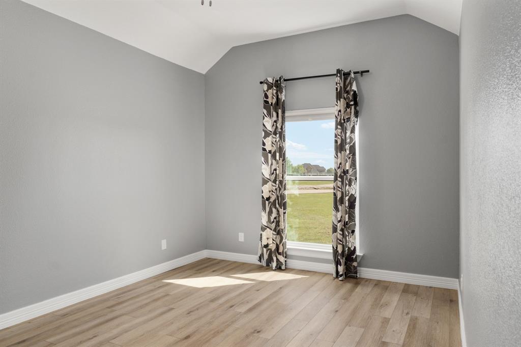 10832 Ridge Country Road Haslet, TX 76052 - Photo 20 of 30 Front bedroom with another walk-in closet.