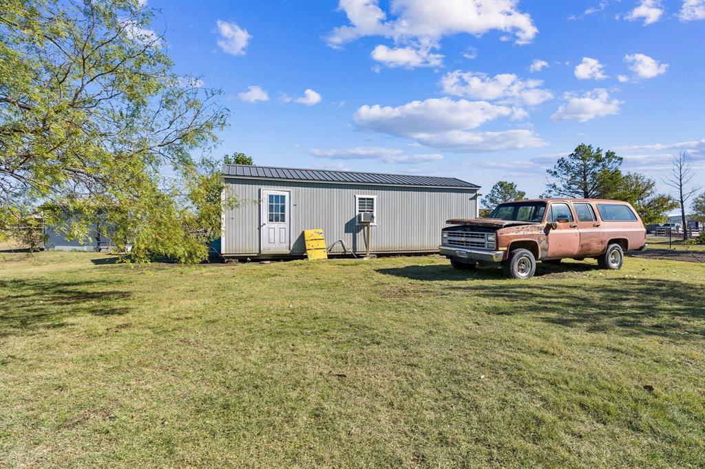 10832 Ridge Country Road Haslet, TX 76052 - Photo 28 of 30 32 X 14 Storage building with roll-up door, could be used for a workshop or man-cave!!