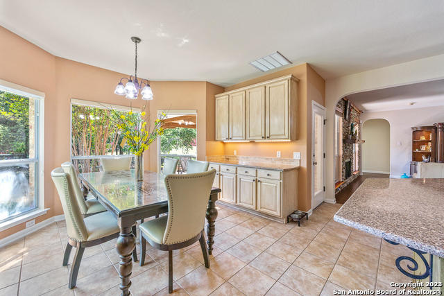 9634 Jason Bend Helotes, TX 78023 - Photo 12 of 43 a dining room with furniture a chandelier and window