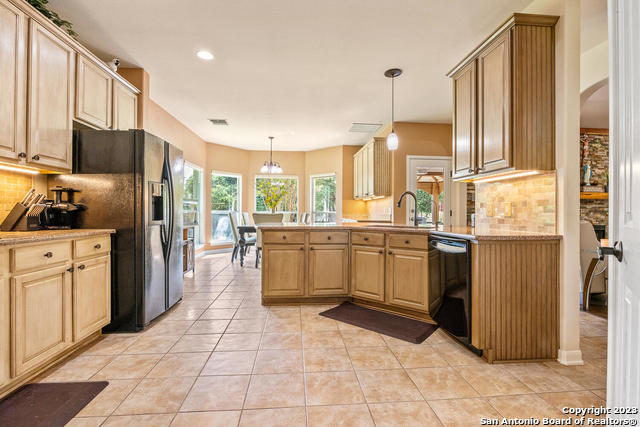 9634 Jason Bend Helotes, TX 78023 - Photo 15 of 43 a kitchen with stainless steel appliances a refrigerator sink and cabinets