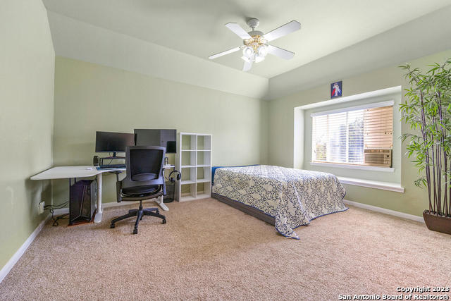 9634 Jason Bend Helotes, TX 78023 - Photo 29 of 43 a bedroom with a bed a desk and chair