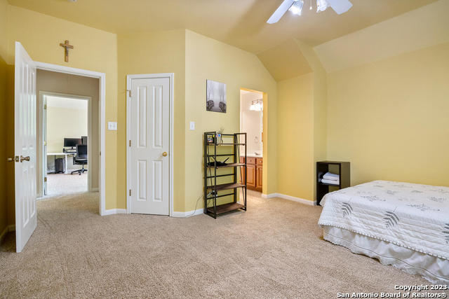 9634 Jason Bend Helotes, TX 78023 - Photo 32 of 43 a bedroom with a bed and a view of bathroom