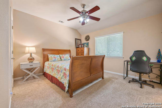 9634 Jason Bend Helotes, TX 78023 - Photo 34 of 43 a bedroom with a bed chair and window
