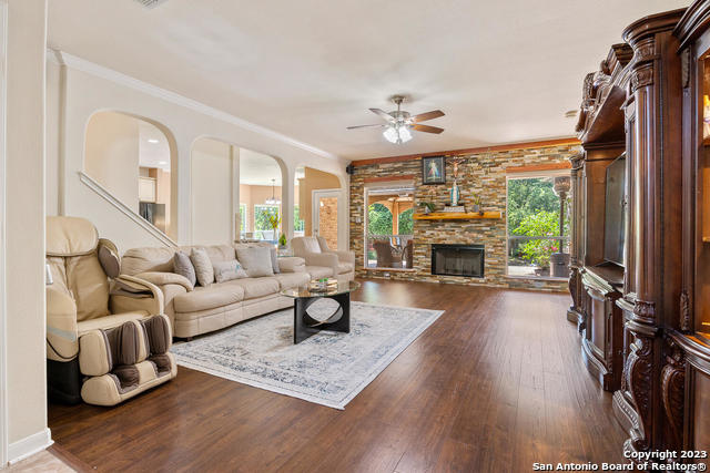 9634 Jason Bend Helotes, TX 78023 - Photo 6 of 43 a living room with furniture a fireplace and a flat screen tv