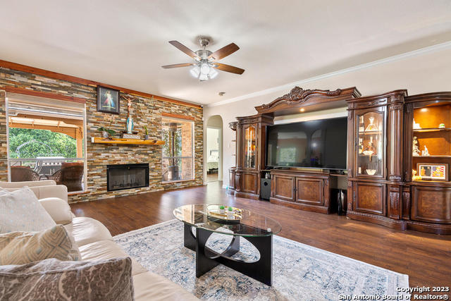9634 Jason Bend Helotes, TX 78023 - Photo 7 of 43 a living room with furniture a flat screen tv and a fireplace