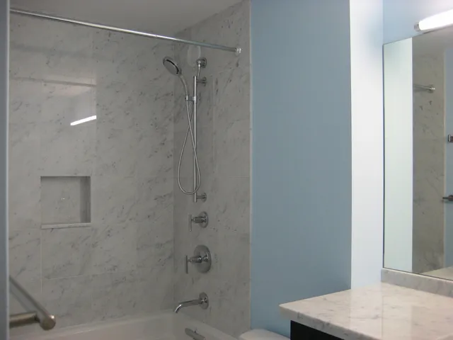 a bathroom with a shower and a toilet sink