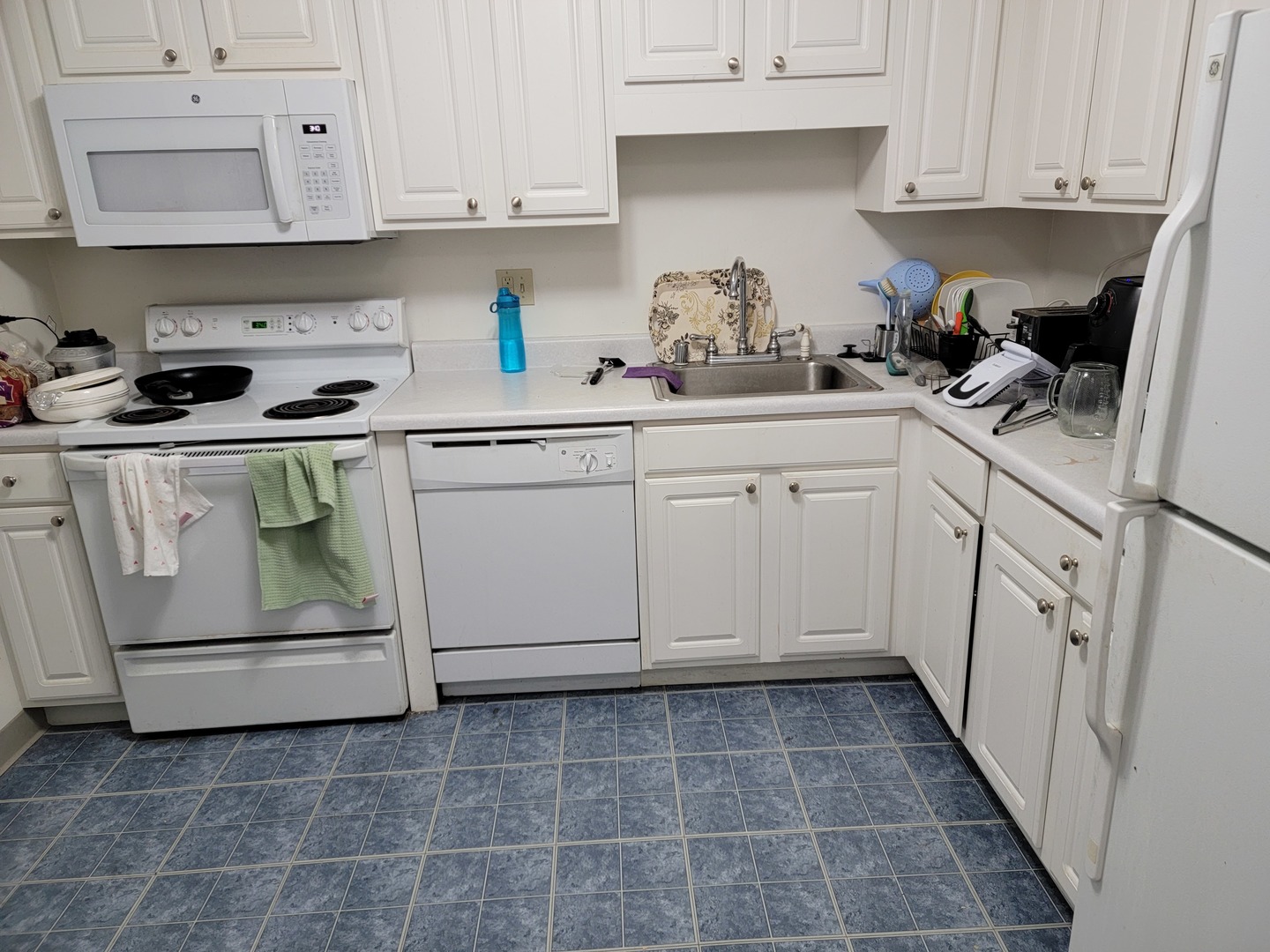 211 East Ohio Street, Unit 1013 Chicago, IL 60611 - Photo 3 of 12 a kitchen with white cabinets and white appliances