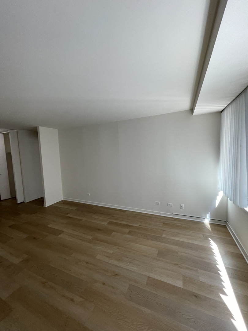 211 East Ohio Street, Unit 1013 Chicago, IL 60611 - Photo 4 of 12 a view of an empty room and window