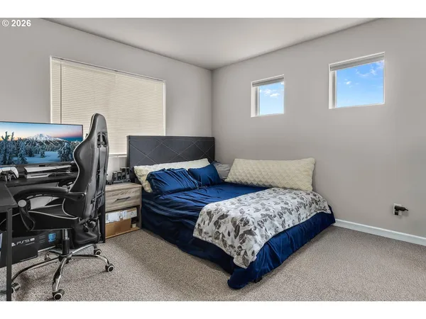 a bedroom with a bed and a desk