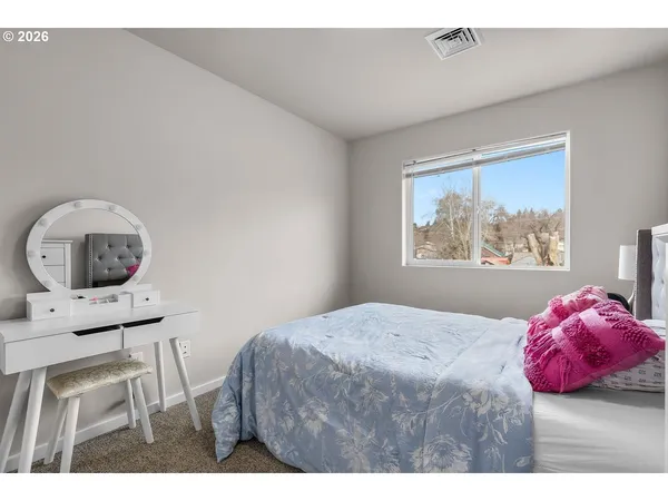 a bedroom with a bed window and a table