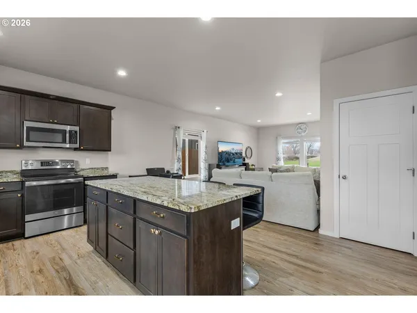 a kitchen with a sink and wooden floor