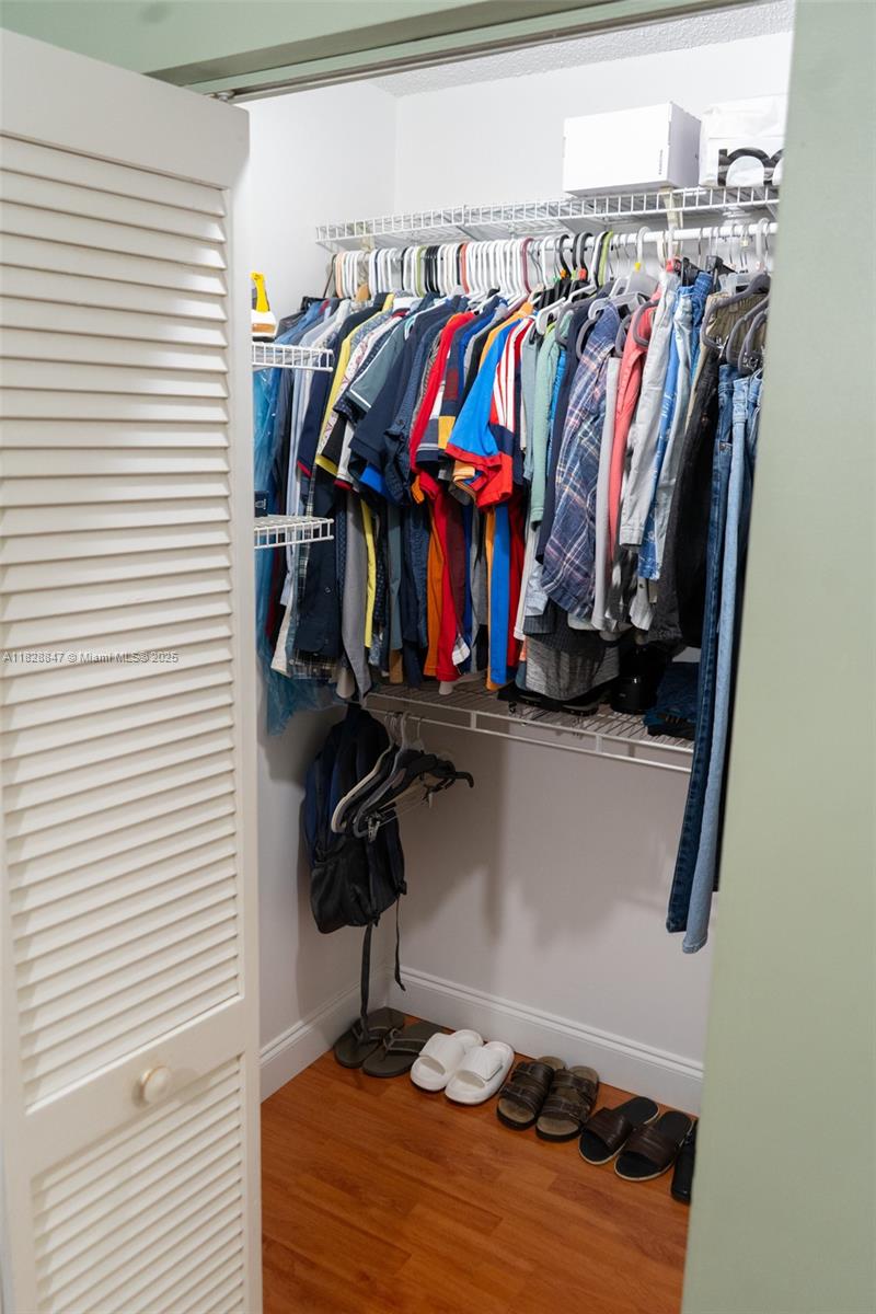 13402 Southwest 153rd Street, Unit 1904 Miami, FL 33177 - Photo 12 of 26 a view of walk in closet with clothes and shoes