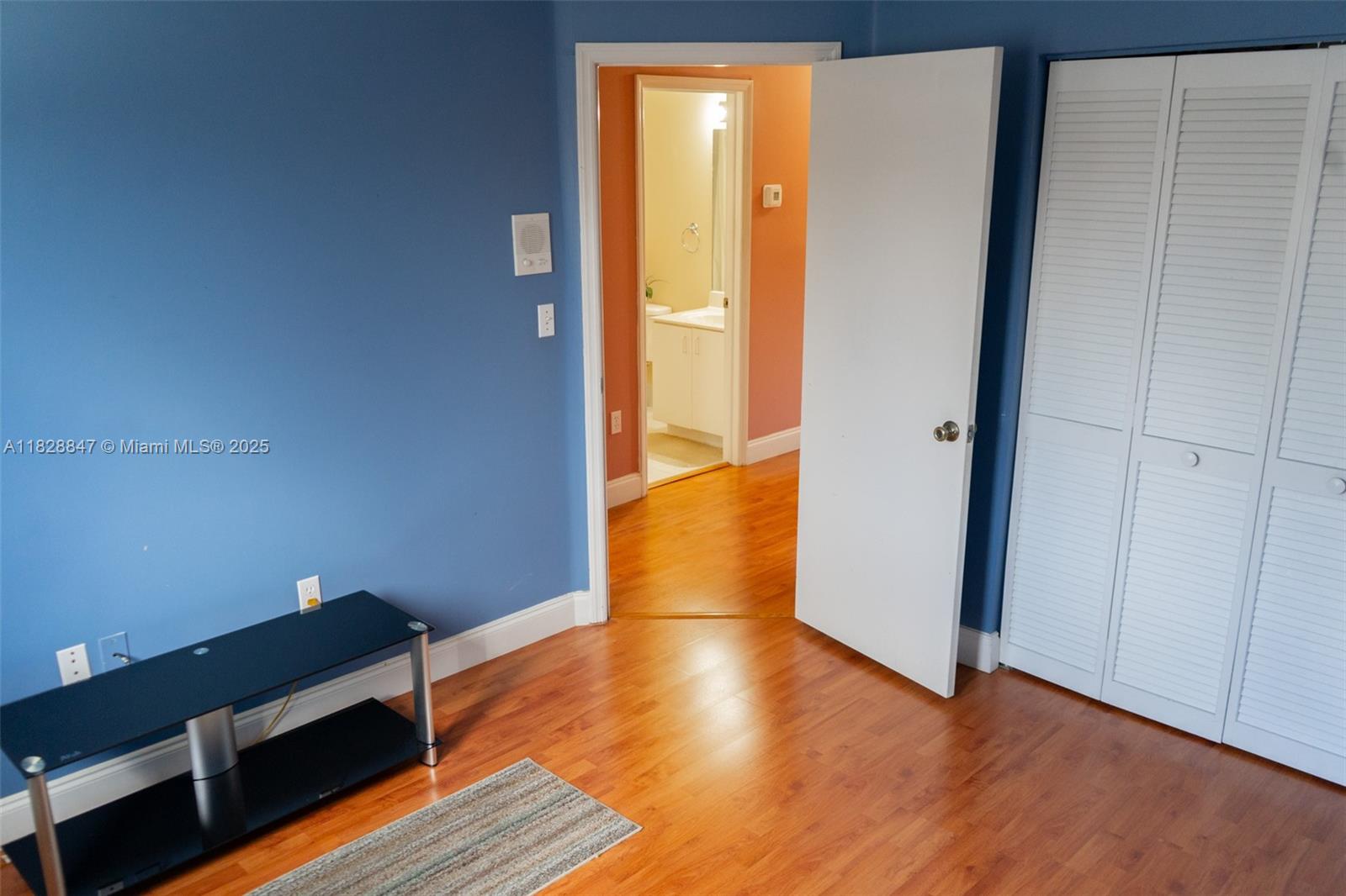 13402 Southwest 153rd Street, Unit 1904 Miami, FL 33177 - Photo 17 of 26 an empty room with wooden floor and entrance