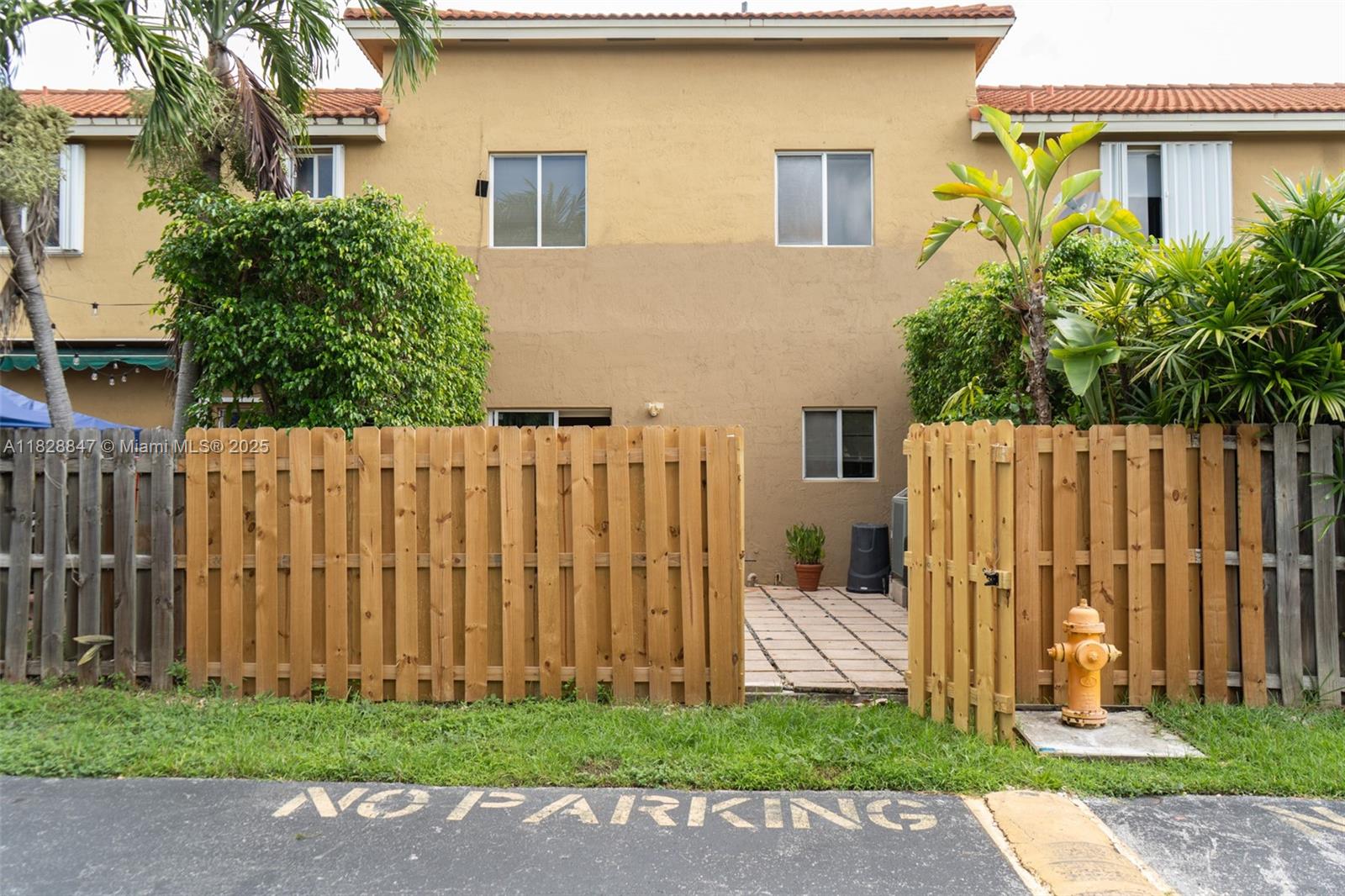 13402 Southwest 153rd Street, Unit 1904 Miami, FL 33177 - Photo 22 of 26 a view of a house with a small yard and wooden fence