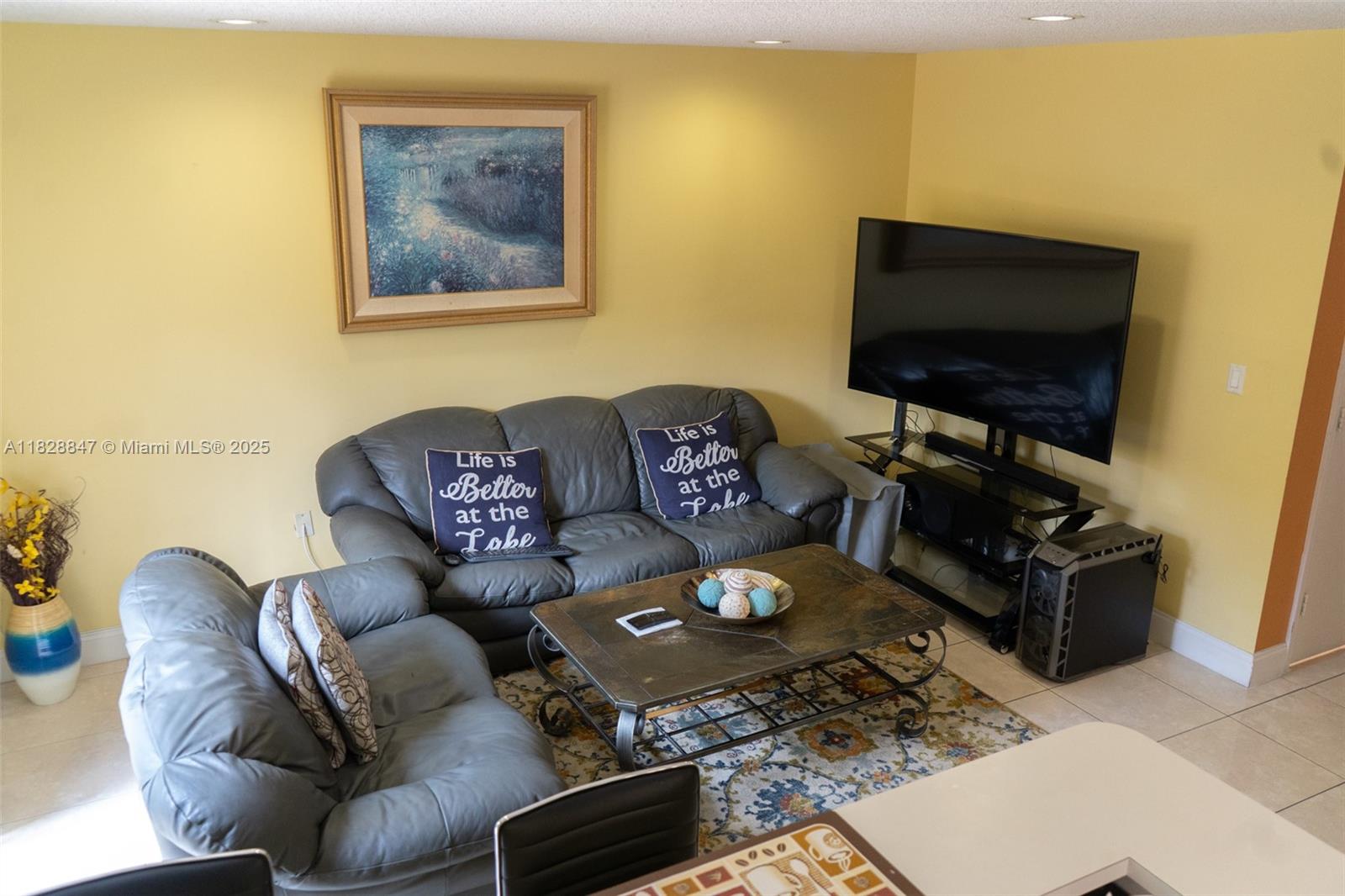 13402 Southwest 153rd Street, Unit 1904 Miami, FL 33177 - Photo 6 of 26 a living room with furniture and a flat screen tv
