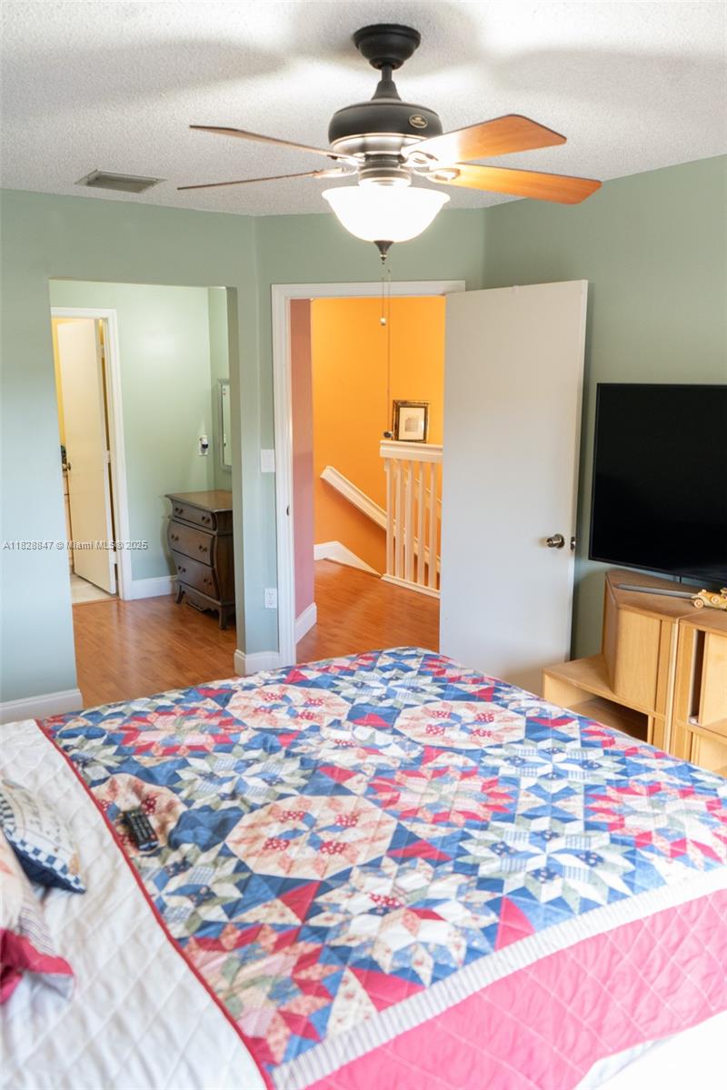 13402 Southwest 153rd Street, Unit 1904 Miami, FL 33177 - Photo 9 of 26 a bedroom with a bed and a flat screen tv