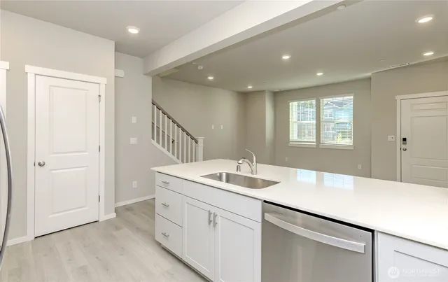 a hallway with sink and mirror