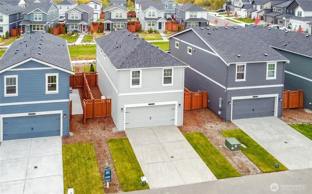 an aerial view of residential houses with yard