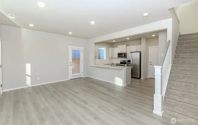 a view of kitchen with refrigerator stove microwave and cabinets