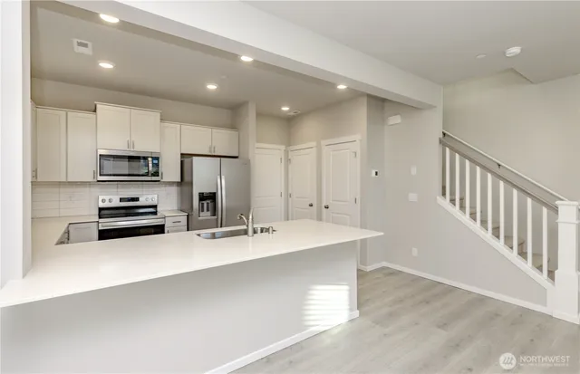 a kitchen with counter top space cabinets and stainless steel appliances