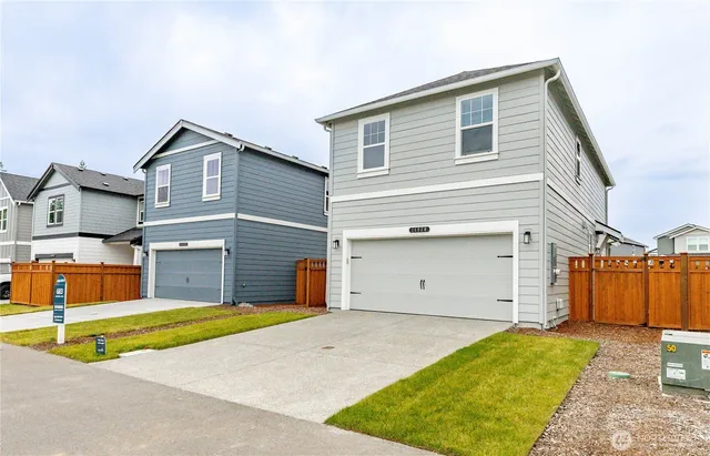 a front view of a house with a yard and garage